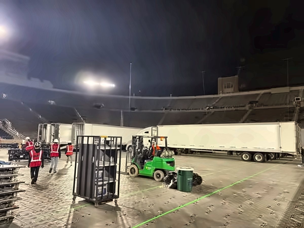 Trailers and forklift on a stadium floor